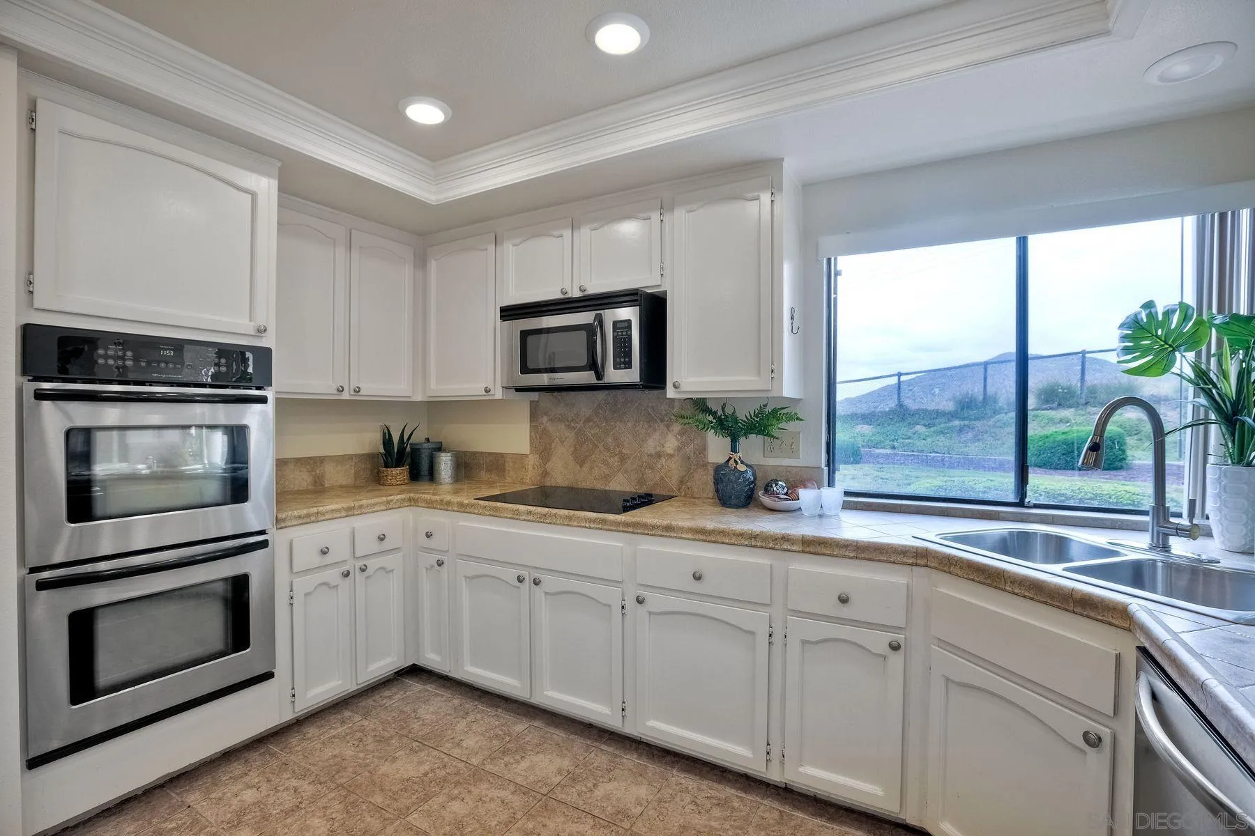 17834 St Andrews Drive Poway, CA 92064 - Photo 12 of 38 a kitchen with a sink stove and microwave