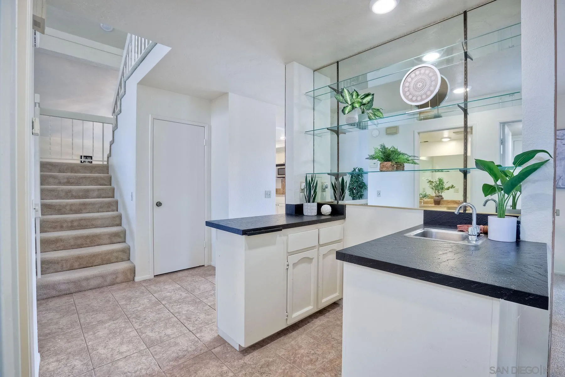 17834 St Andrews Drive Poway, CA 92064 - Photo 18 of 38 a kitchen with granite countertop a sink a stove and cabinets