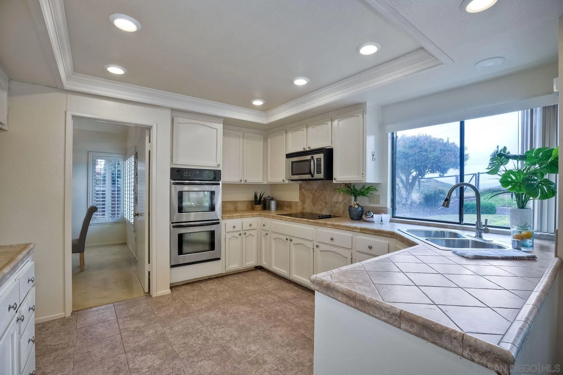 17834 St Andrews Drive Poway, CA 92064 - Photo 10 of 38 a kitchen with sink refrigerator and large window