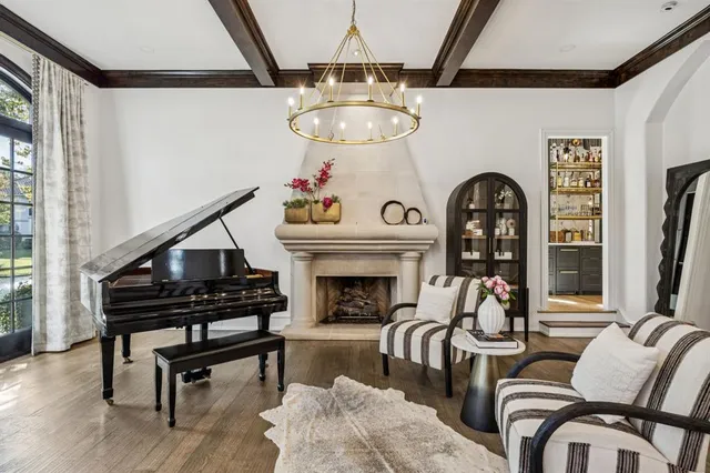 a living room with furniture and a chandelier