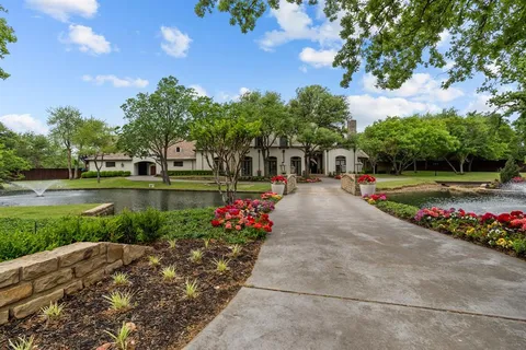 a view of a garden with flowers and trees