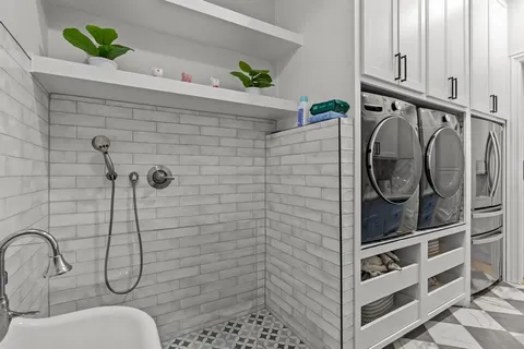 a bedroom with a bed and a flat tv screen on dresser