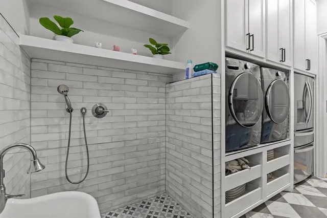 a bedroom with a bed and a flat tv screen on dresser