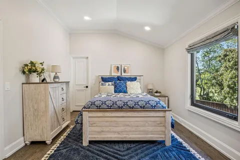 a bedroom with furniture and a wooden floor