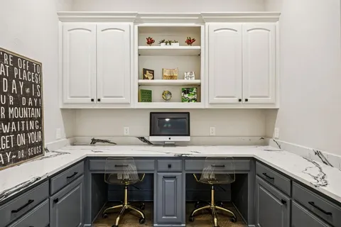 a en suite bathroom with a double vanity sink and a mirror