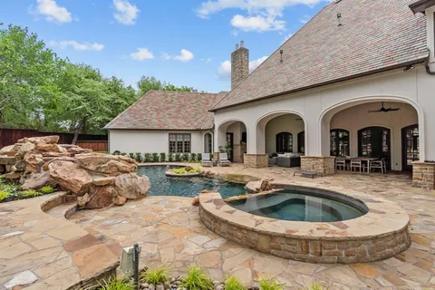 a view of swimming pool with outdoor seating and trees