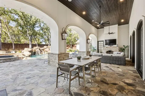a view of a white house with a big yard and large tree