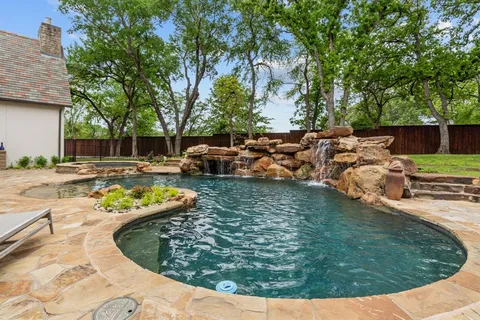 a view of a house with swimming pool and a yard