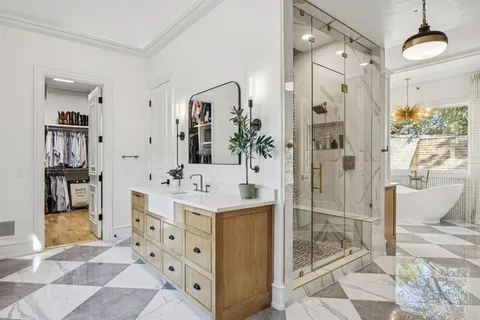 a white bath tub sitting in front of a window