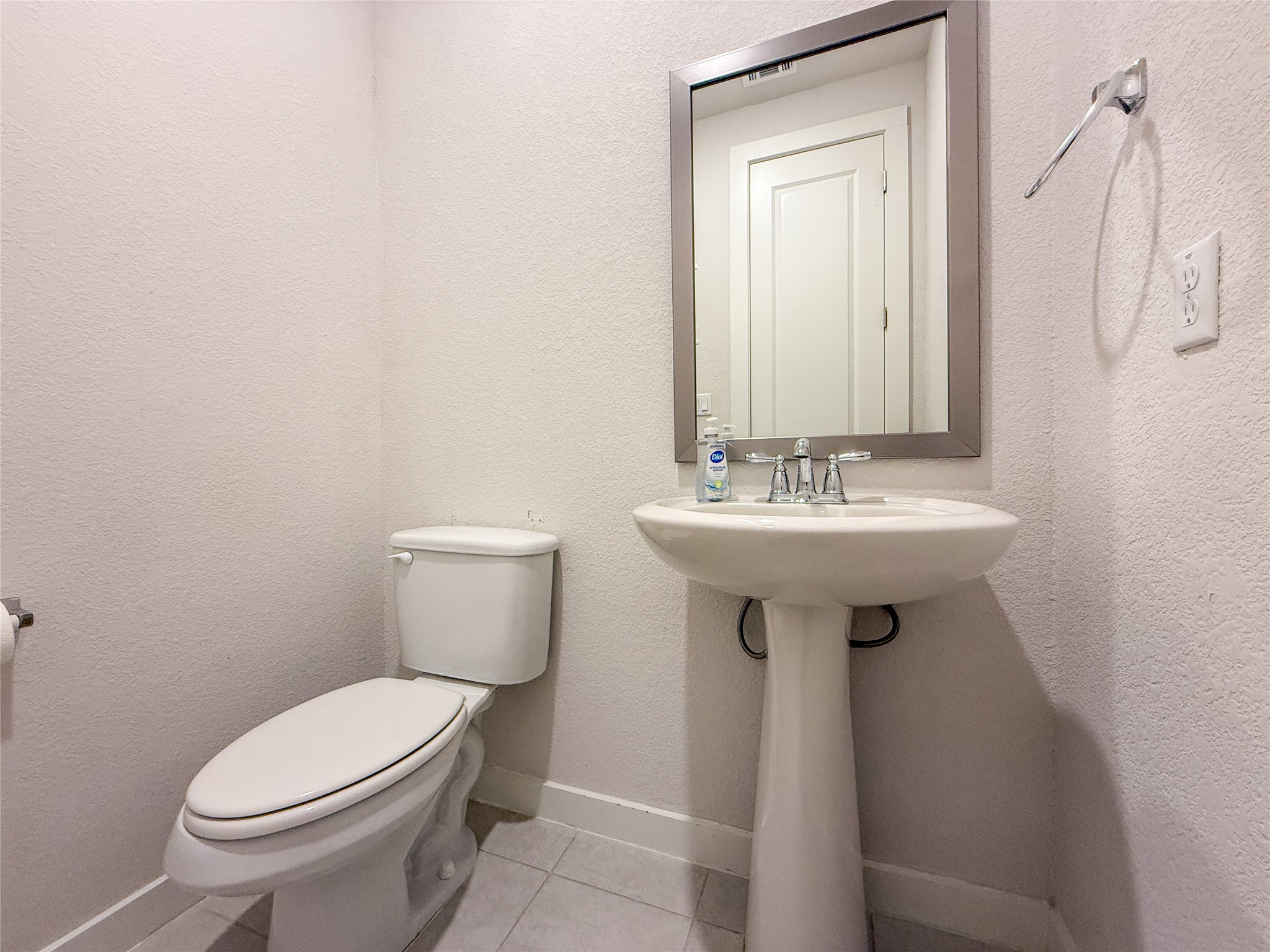 249 Heartleaf Road San Marcos, TX 78666 - Photo 23 of 38 A compact, convenient powder room featuring a sleek pedestal sink and tile flooring.