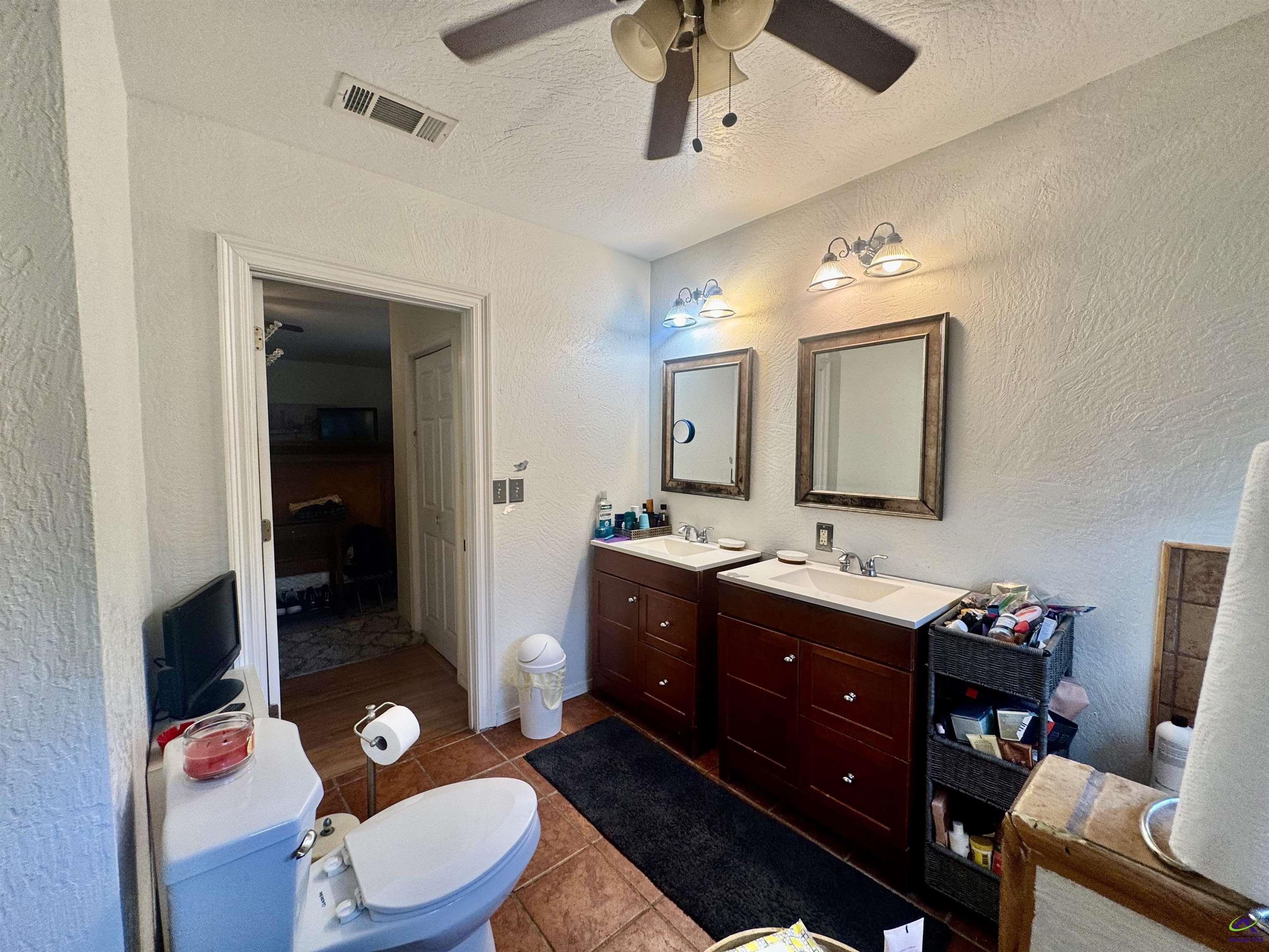 914 Adderton Street Americus, GA 31719 - Photo 31 of 53 a bathroom with a granite countertop toilet sink and mirror