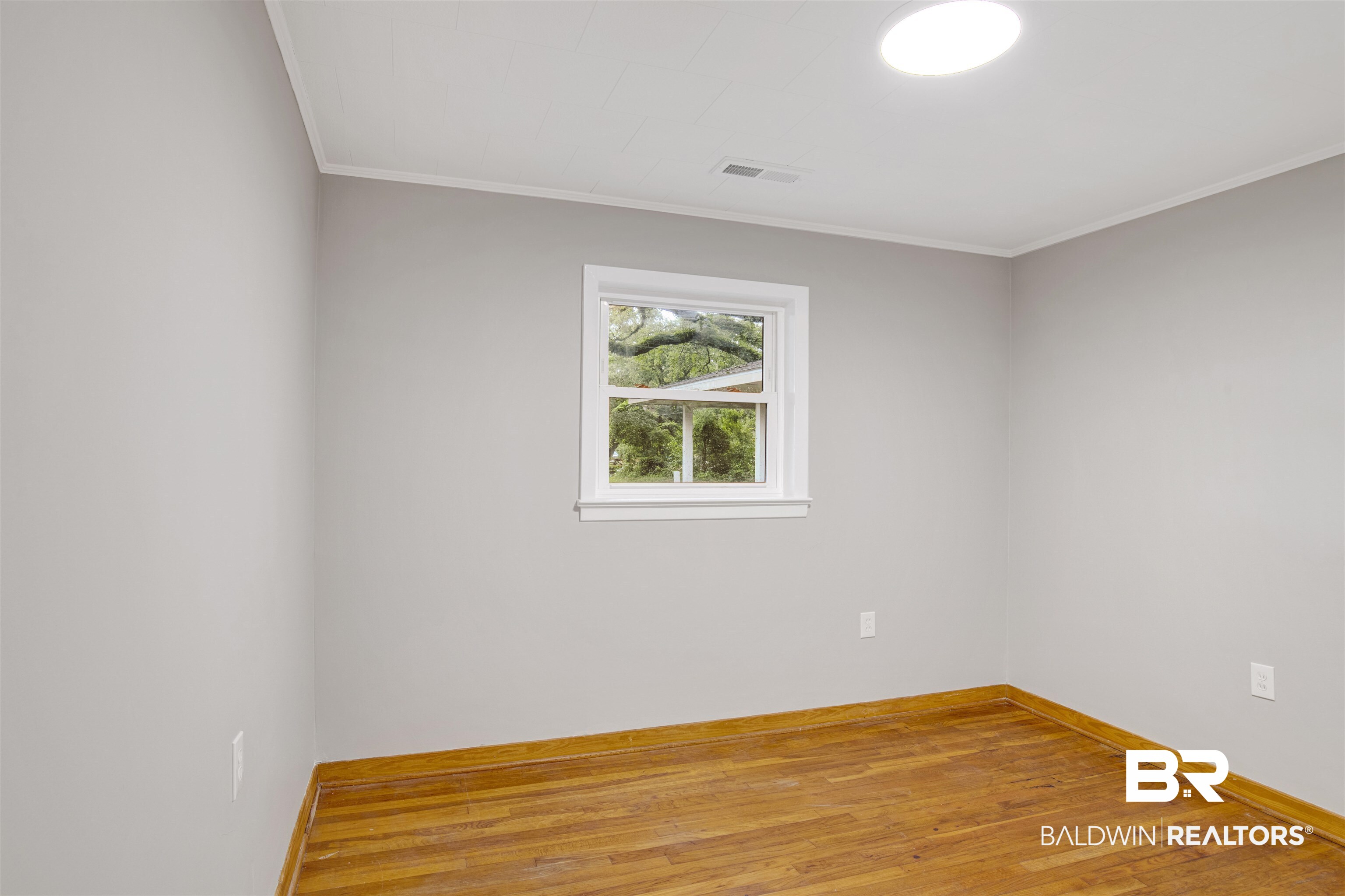18347 Underwood Road Foley, AL 36535 - Photo 13 of 40 Spare room with ornamental molding, baseboards, and light wood-type flooring