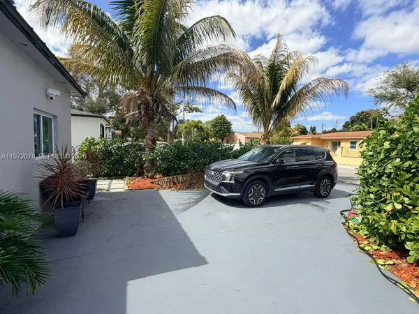 a view of a car parked in front of a house