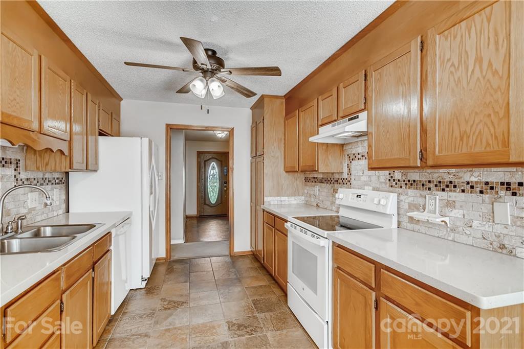 619 Breckenridge Road Kannapolis, NC 28083 - Photo 11 of 33 a kitchen with stainless steel appliances a sink stove and cabinets