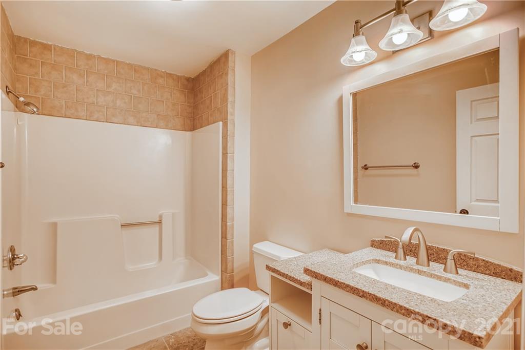 619 Breckenridge Road Kannapolis, NC 28083 - Photo 24 of 33 a bathroom with a granite countertop sink toilet a mirror and shower