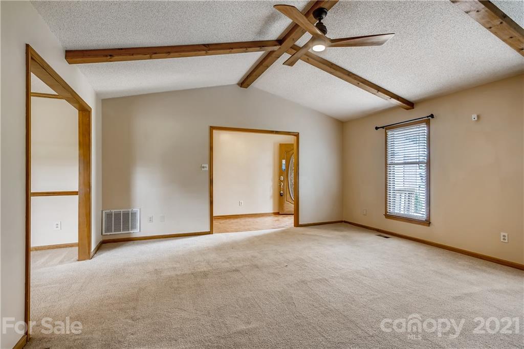 619 Breckenridge Road Kannapolis, NC 28083 - Photo 7 of 33 an empty room with chandelier fan and windows