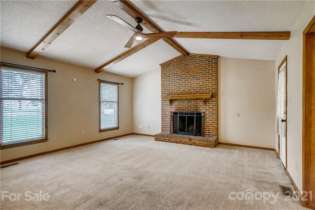 619 Breckenridge Road Kannapolis, NC 28083 - Photo 8 of 33 a view of an empty room with a fireplace and a window