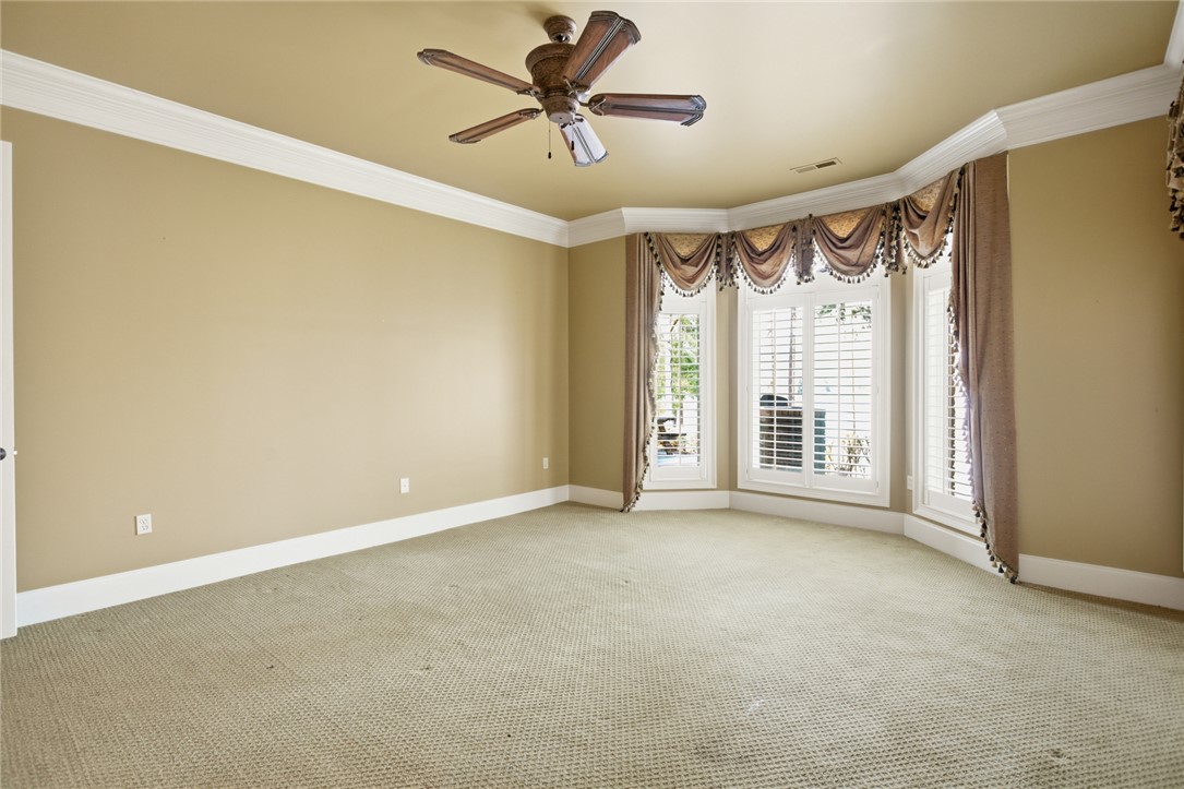610 Highridge Drive Seneca, SC 29672 - Photo 35 of 50 This spacious room features a bay window, crown molding, and a ceiling fan.