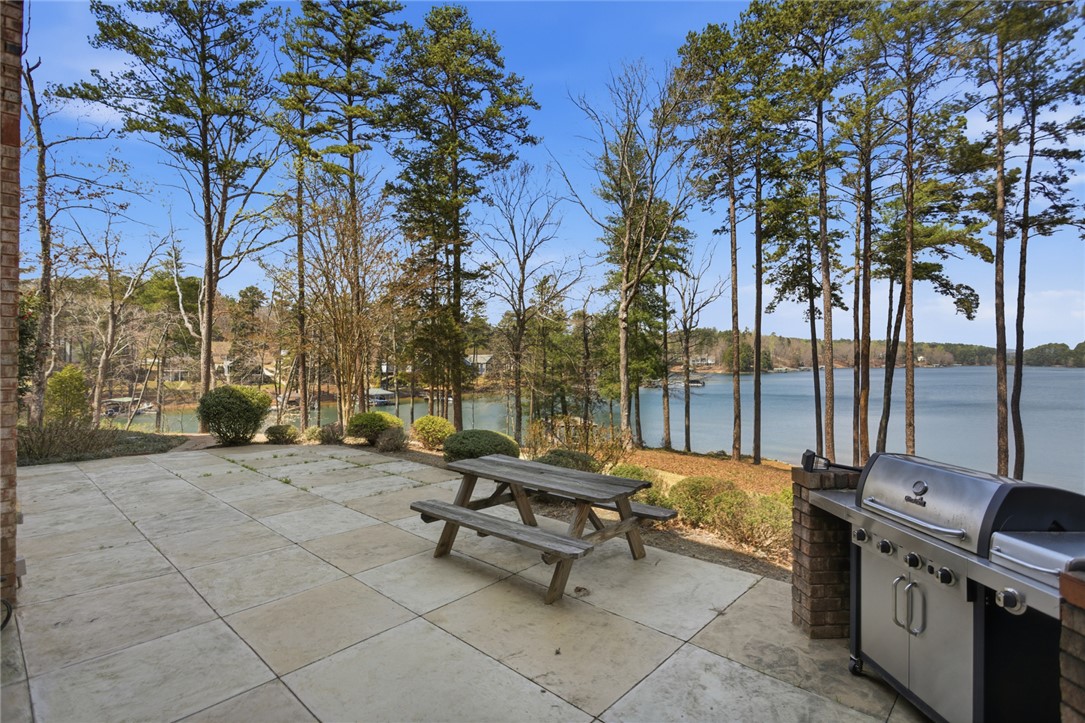 610 Highridge Drive Seneca, SC 29672 - Photo 48 of 50 Enjoy outdoor entertaining with a spacious patio, built-in grill, and serene Lake Keowee views.