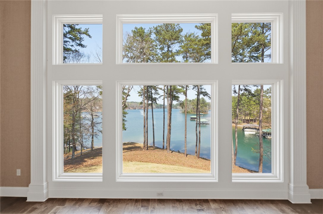 610 Highridge Drive Seneca, SC 29672 - Photo 7 of 50 This living area offers expansive water views through large windows, creating a serene indoor-outdoor connection.