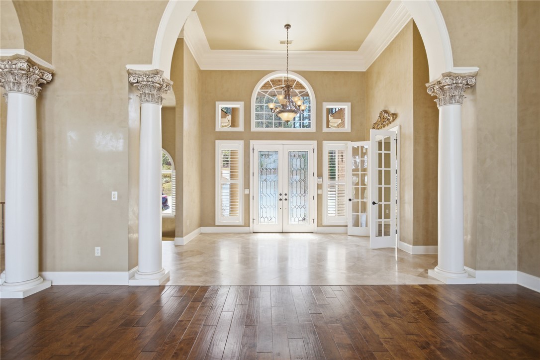 610 Highridge Drive Seneca, SC 29672 - Photo 9 of 50 This grand foyer showcases elegant architectural details, including stately columns and an arched entryway.