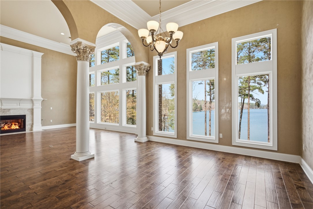 610 Highridge Drive Seneca, SC 29672 - Photo 10 of 50 This expansive great room offers panoramic lake views, a grand fireplace, and hardwood floors.