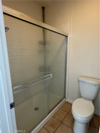 a bathroom with a toilet and a shower