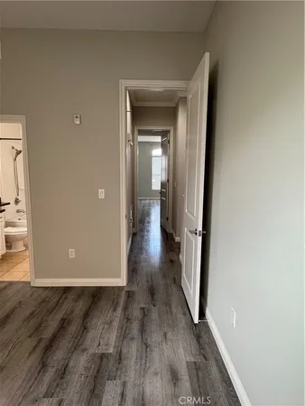 a view of a hallway with wooden floor