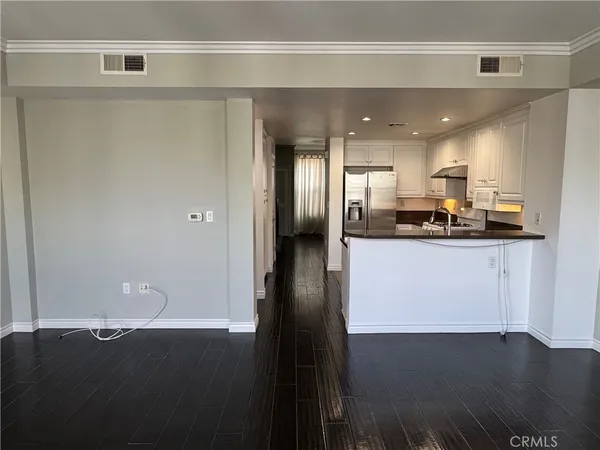 a view of kitchen with stainless steel appliances refrigerator oven and cabinets