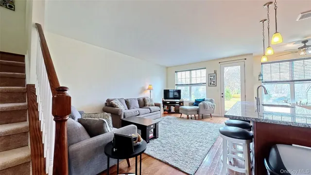a living room with lots of furniture and kitchen view