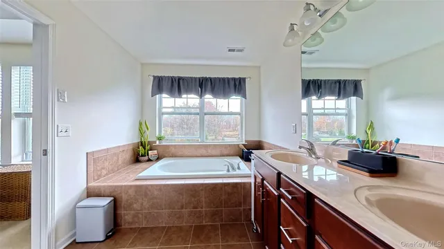 a bedroom with a bed a mirror and dresser