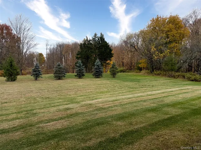 a backyard of a house with glass top table and chairs
