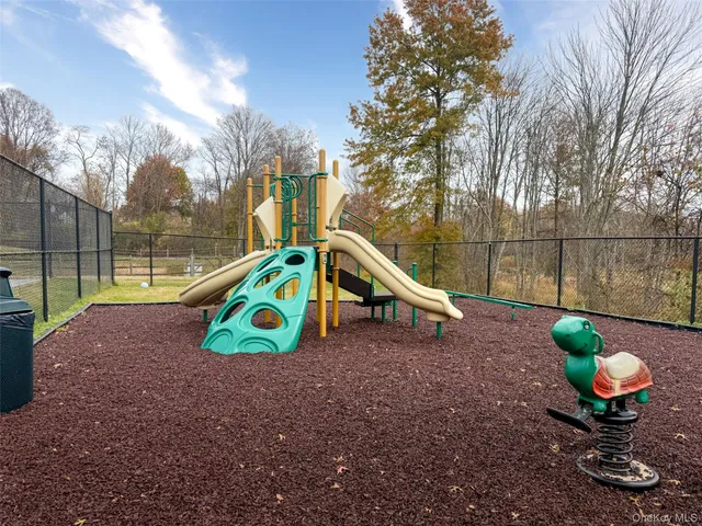 a view of a house with a big yard and large trees