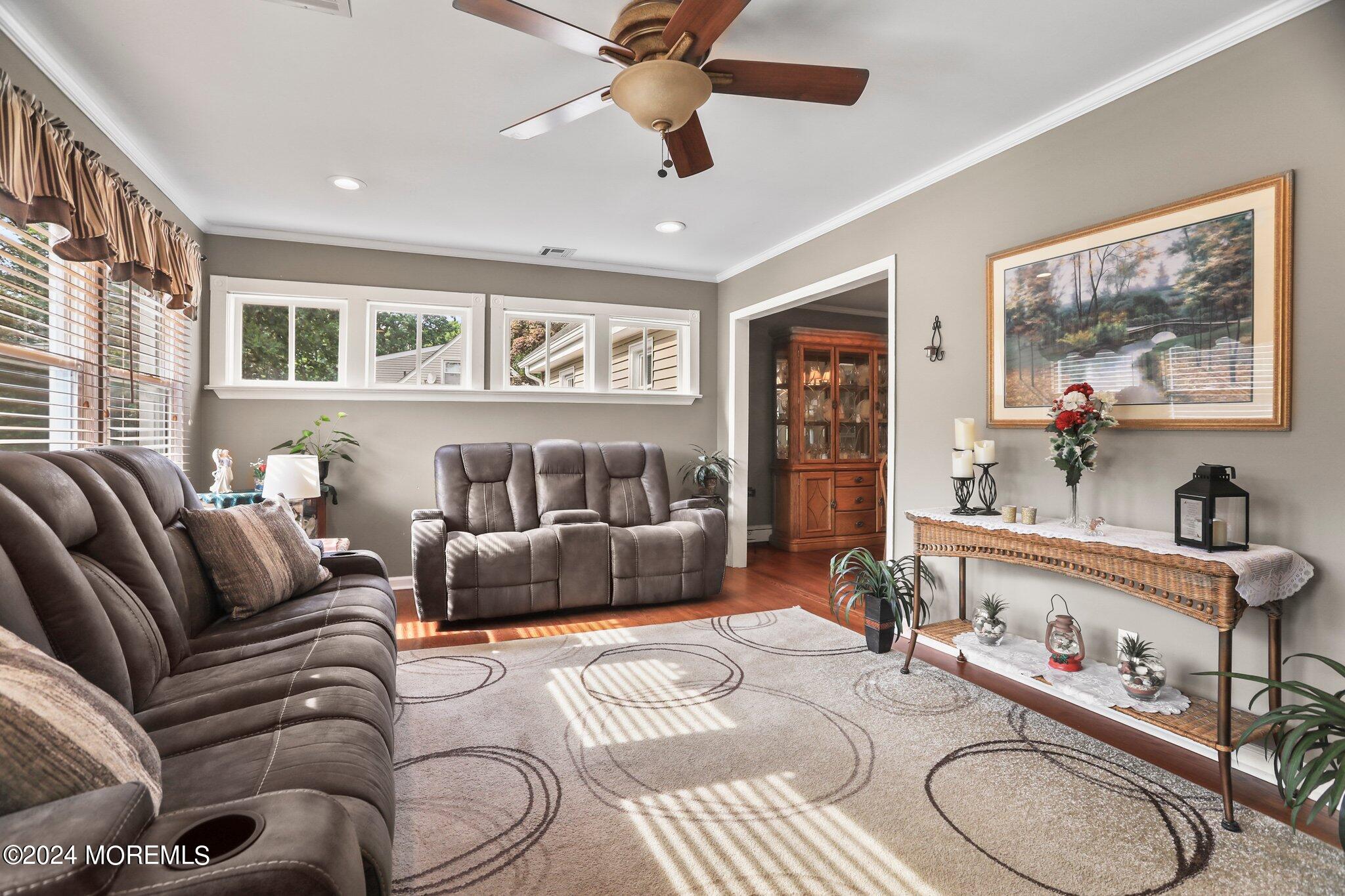 202 Highwood Road Oakhurst, NJ 07755 - Photo 19 of 48 a living room with furniture ceiling fan and a window