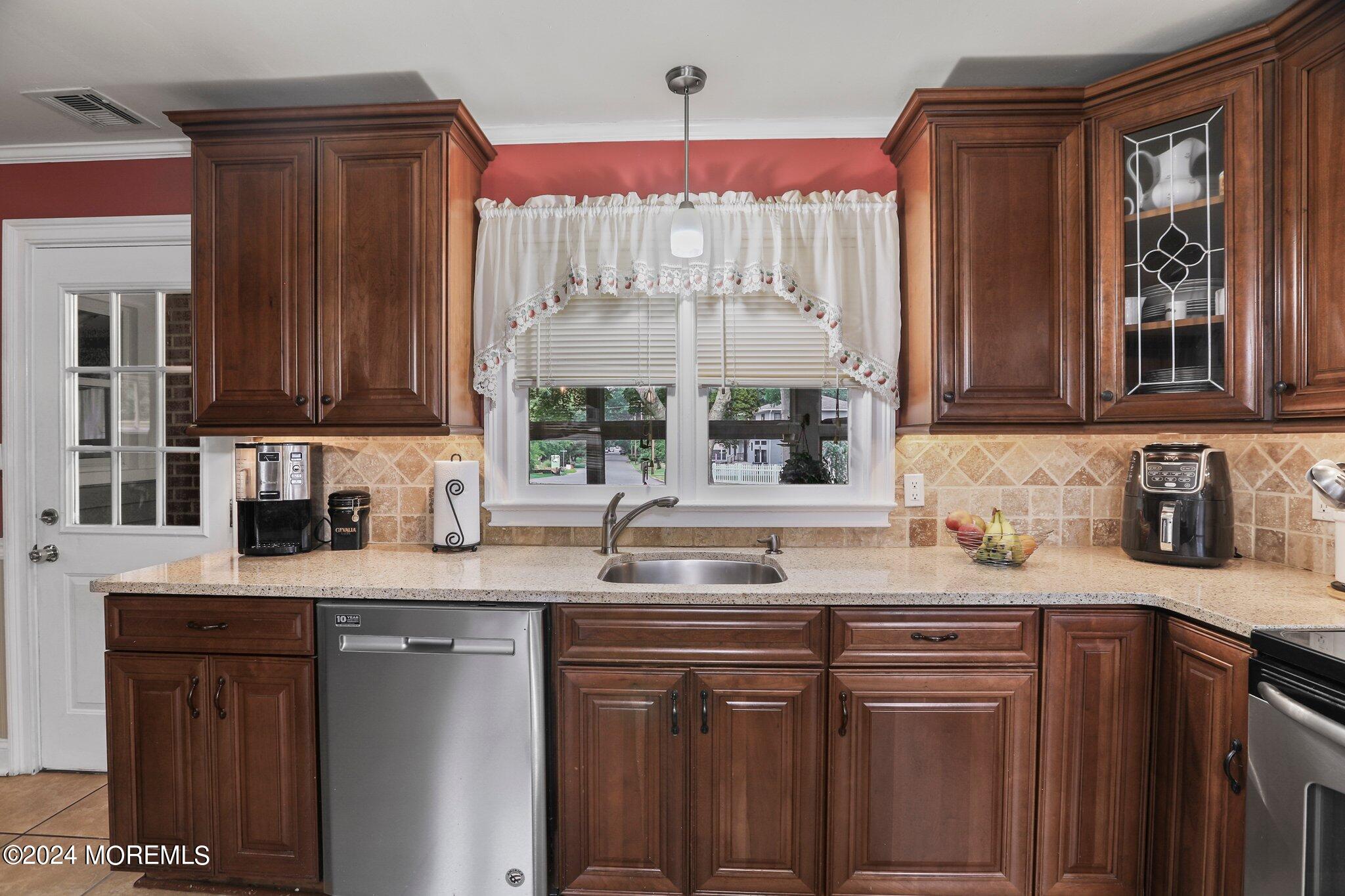 202 Highwood Road Oakhurst, NJ 07755 - Photo 25 of 48 a kitchen with a sink a window and cabinets