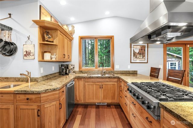 a kitchen with a sink stove and cabinets