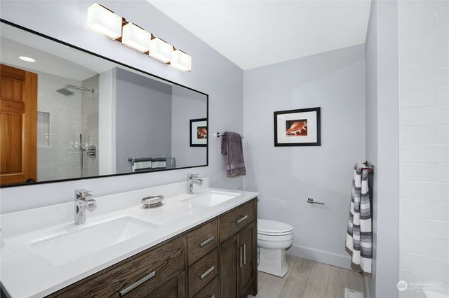 a view of a patio with couches table and chairs and wooden floor