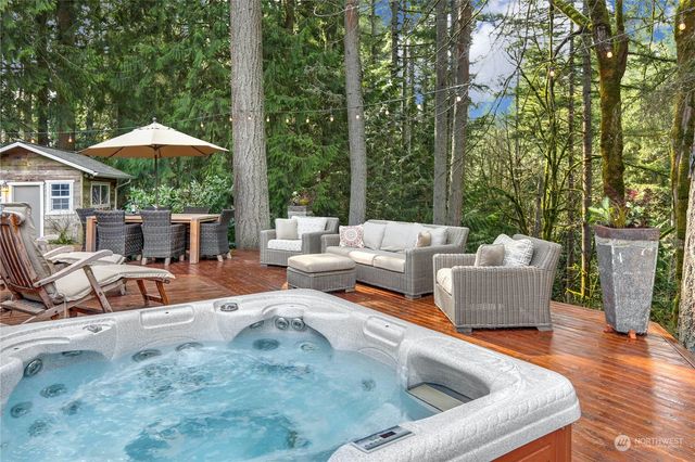 a view of a patio with chairs and large trees