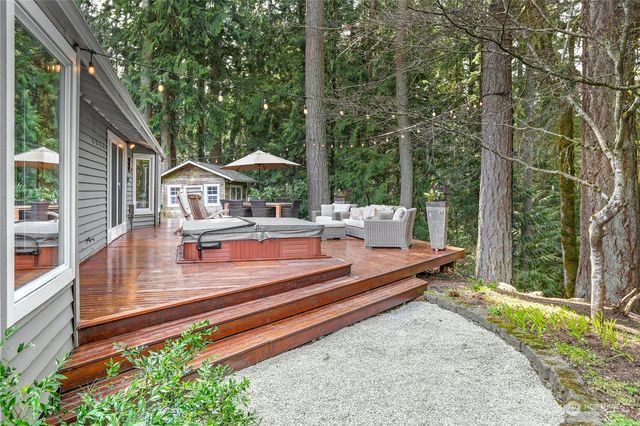 a front view of house with small garden and outdoor seating