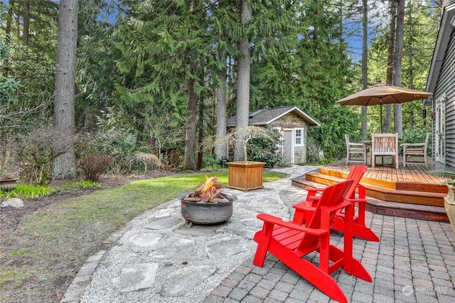 a view of a house with backyard and sitting area