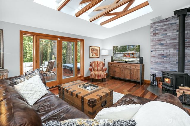 a living room with furniture a rug and a floor to ceiling window