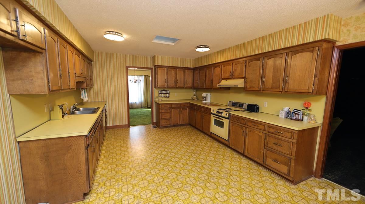 210 Queensferry Road Cary, NC 27511 - Photo 5 of 14 a kitchen with stainless steel appliances granite countertop a sink a stove and a refrigerator