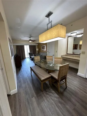 a dining room with furniture and wooden floor