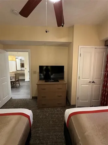 a bedroom with a bed and a television
