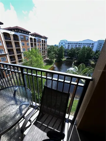 a view of a balcony with wooden floor and outdoor space