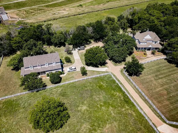 an aerial view of a house with yard swimming pool and outdoor seating
