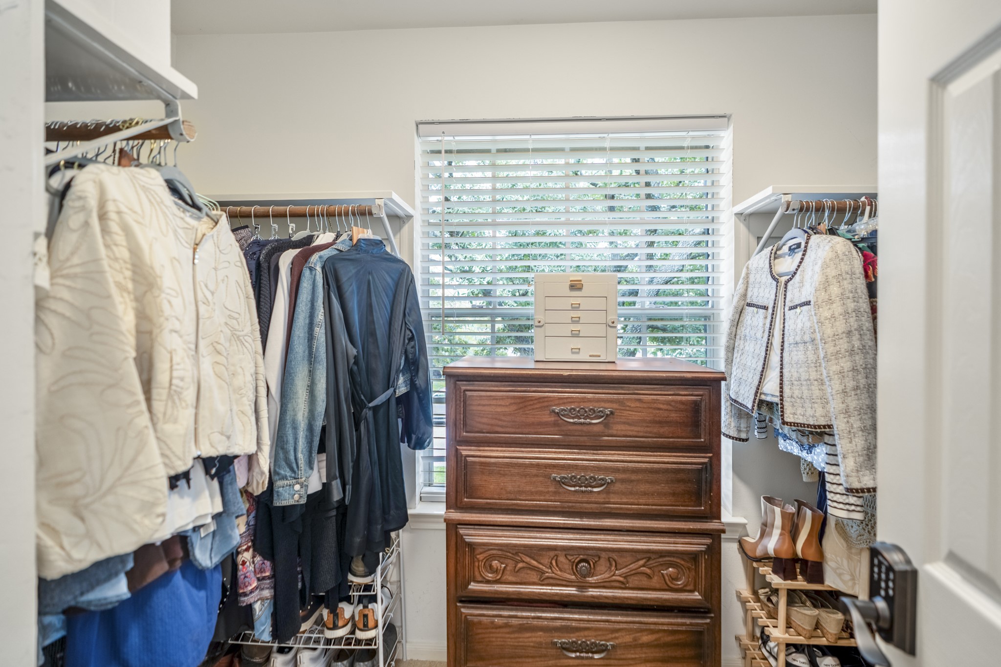 20235 Eden Pines Spring, TX 77379 - Photo 21 of 50 Inside the primary walk-in closet, storage runs along both sides with hanging space, shelving & room to keep everything organized. A window at the back brings in natural light, while new LED closet lighting adds another practical upgrade overhead.