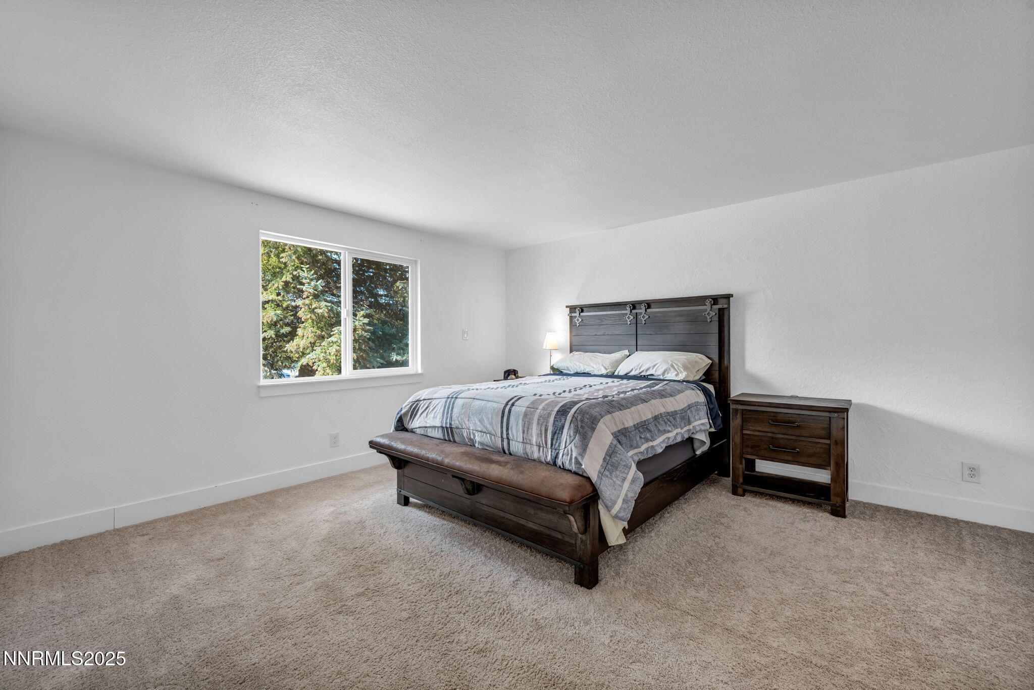 17265 Cold Springs Drive Reno, NV 89508 - Photo 17 of 52 a bed sitting in a bedroom next to a lamp