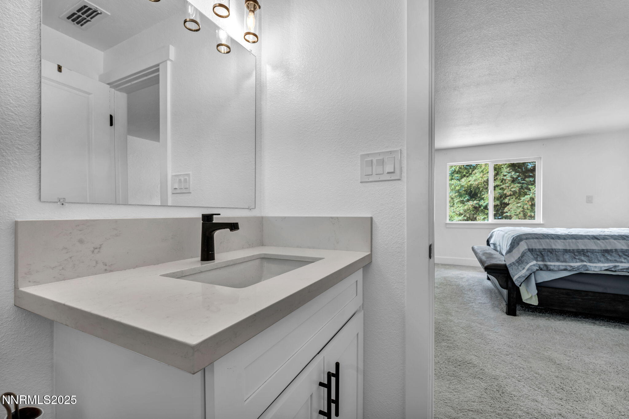 17265 Cold Springs Drive Reno, NV 89508 - Photo 22 of 52 a en suite bathroom with a sink and a mirror