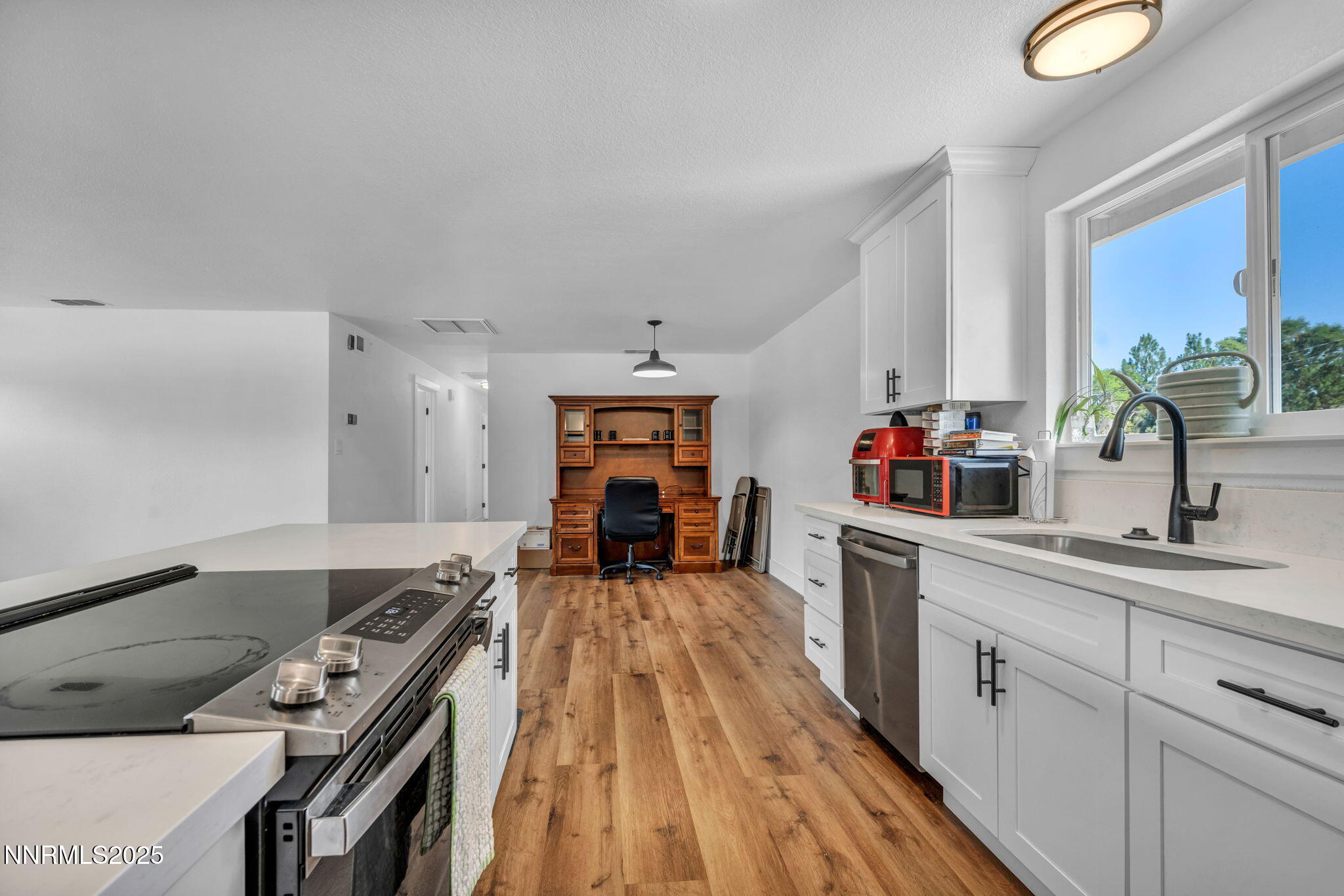 17265 Cold Springs Drive Reno, NV 89508 - Photo 38 of 52 a kitchen with wooden floor a sink and a stove